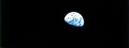 alt text: a picture of Earth taken from space, the lower part of the planet eclipsed in darkness.